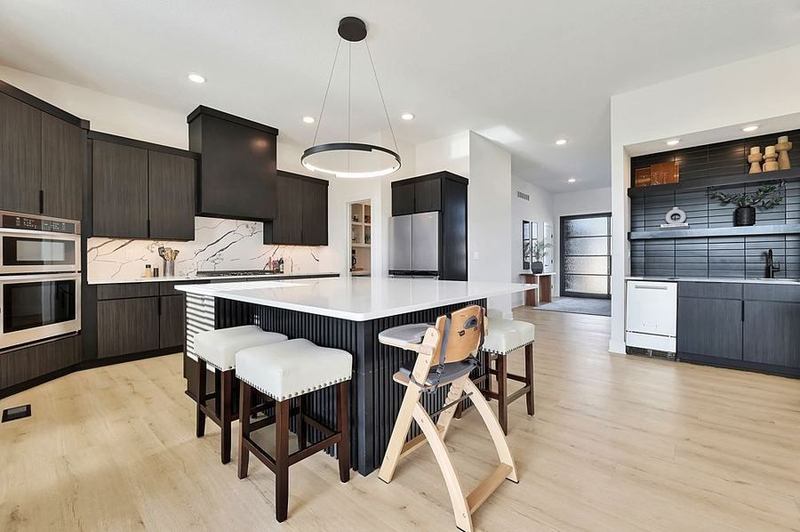 Contemporary kitchen with a full-slab quartz backsplash and a fluted island in a home featured on our work page at 5915 W Kollmeyer Court – Wichita, KS